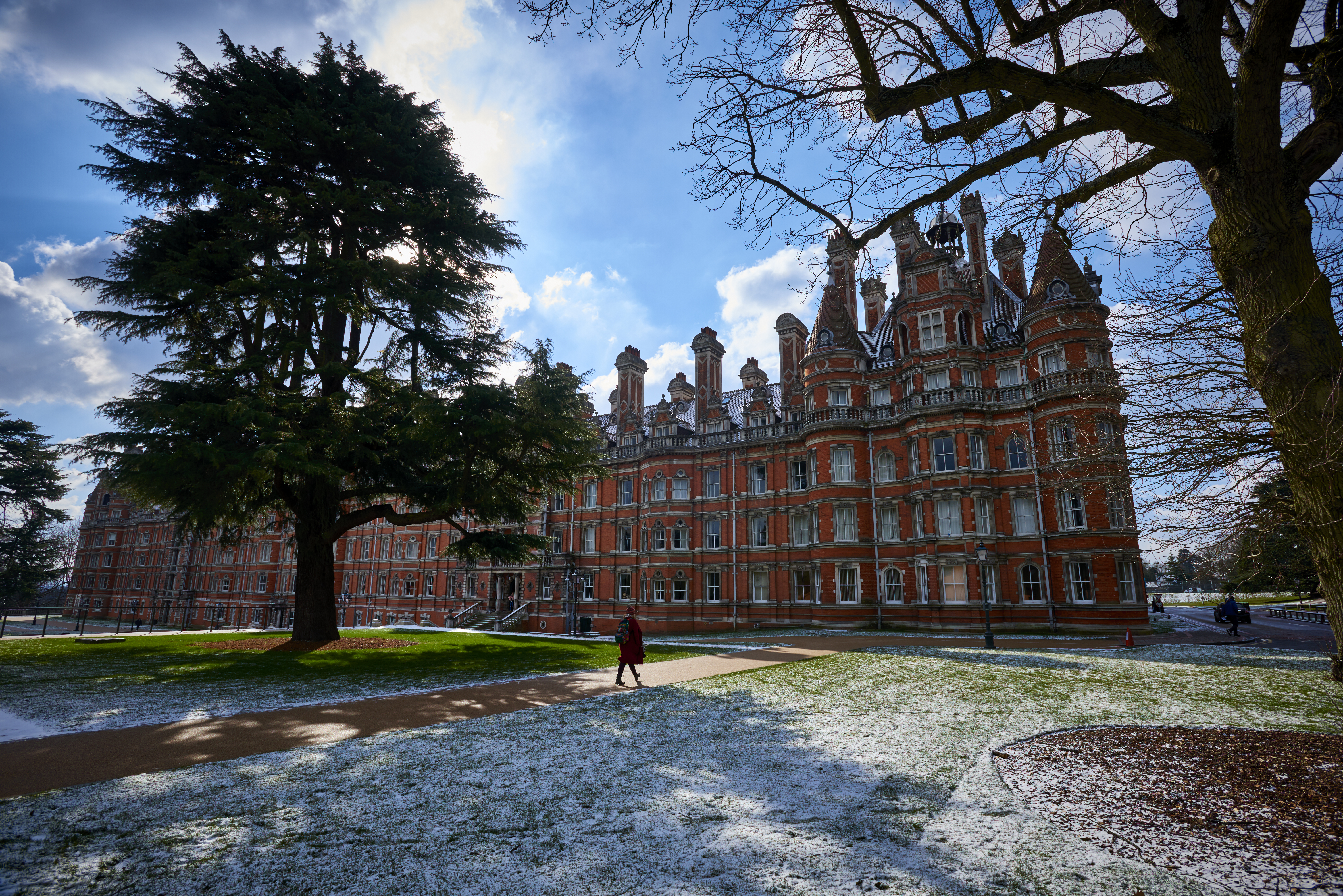 red brick university building of Royal Holloway with grassy courtyard