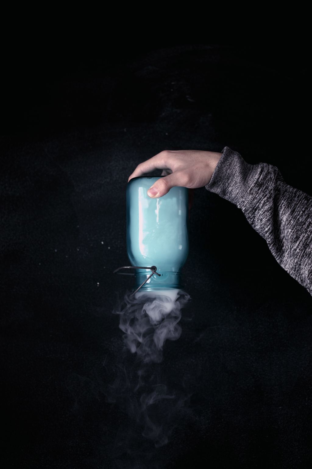 smoke being trapped in a bottle that is held upside down