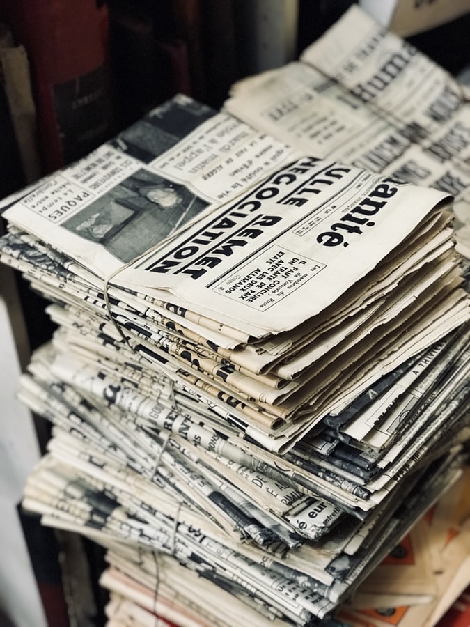 stack of folded old black and white newspapers