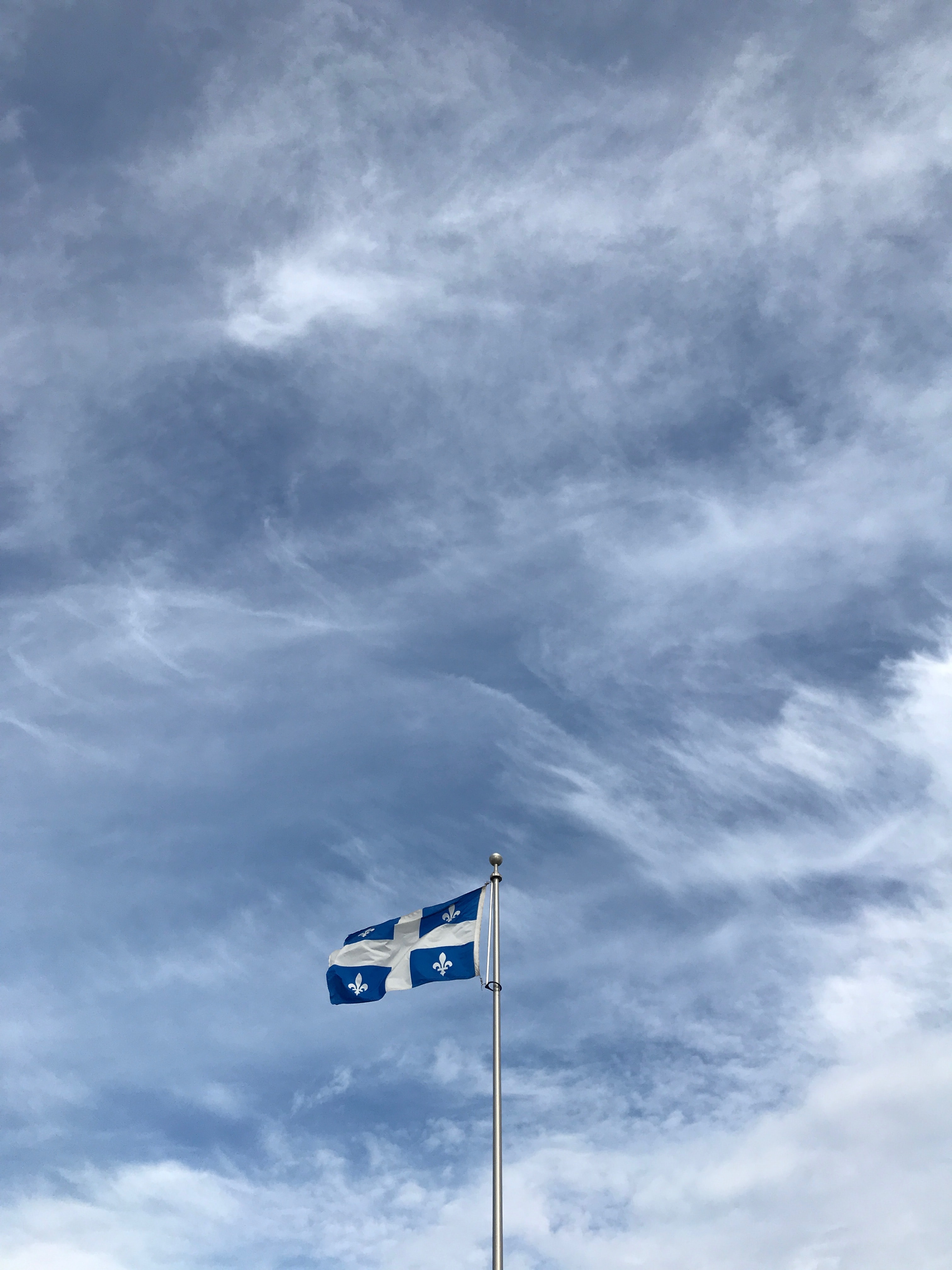 Quebec flag in front of cloudy sky